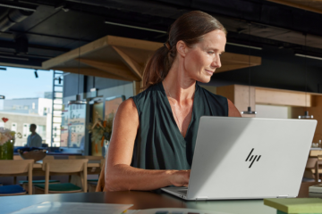 HP Laptop on Table with woman working in a hybrid environment